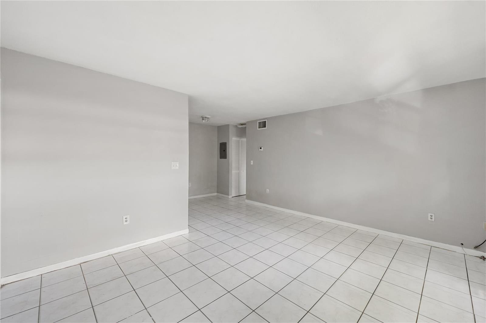 An empty room with light gray walls and white tiled flooring — 1925 Madison Street # 14, Hollywood FL 33020, HOLLYWOOD, FL