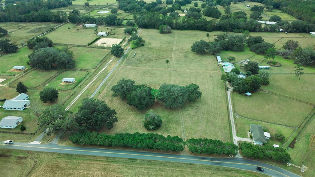 An aerial view shows a large rural property with multiple buildings, pastures, and tree clusters — 4600 NW 95TH AVENUE ROAD, OCALA, FL