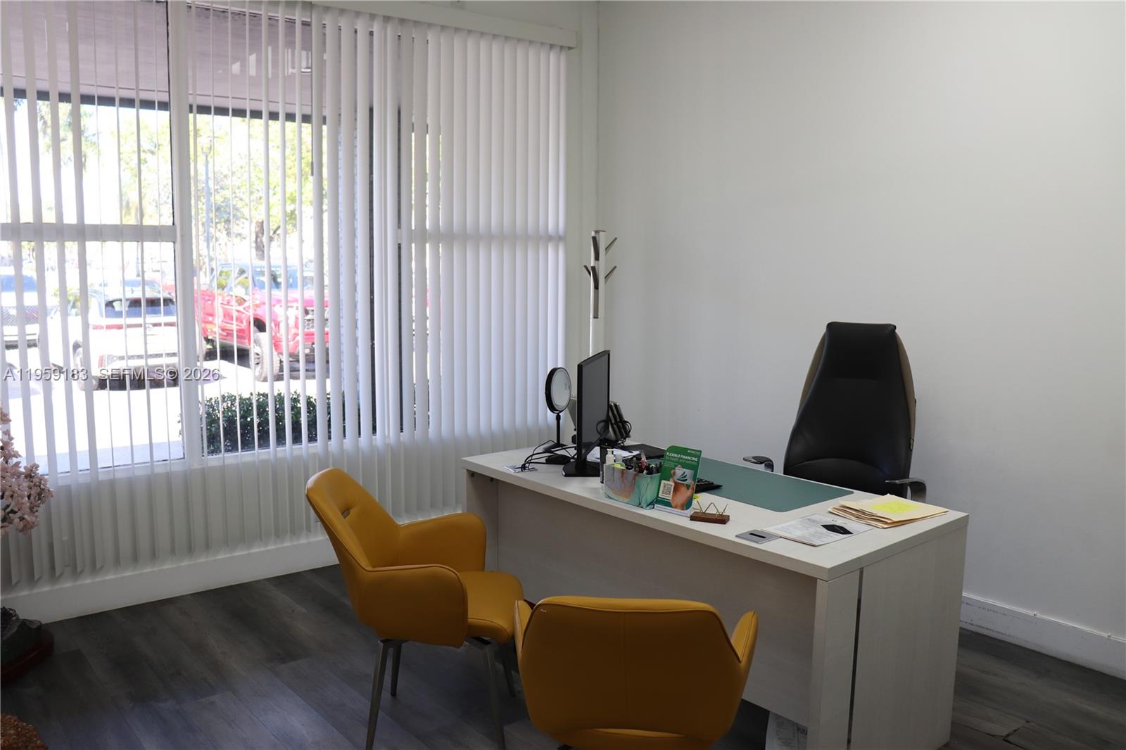 An office features a white desk, two yellow chairs, a black chair, and vertical blinds — 3724-3728 Davie Rd, Davie FL 33314, DAVIE, FL