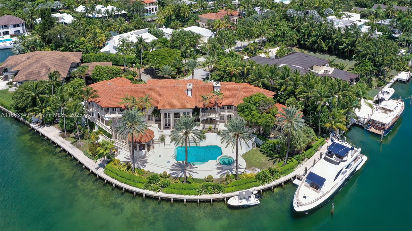 An aerial view of a waterfront mansion with a pool, dock, and two yachts — 260 Cape Florida Dr, Key Biscayne FL 33149, KEY BISCAYNE, FL
