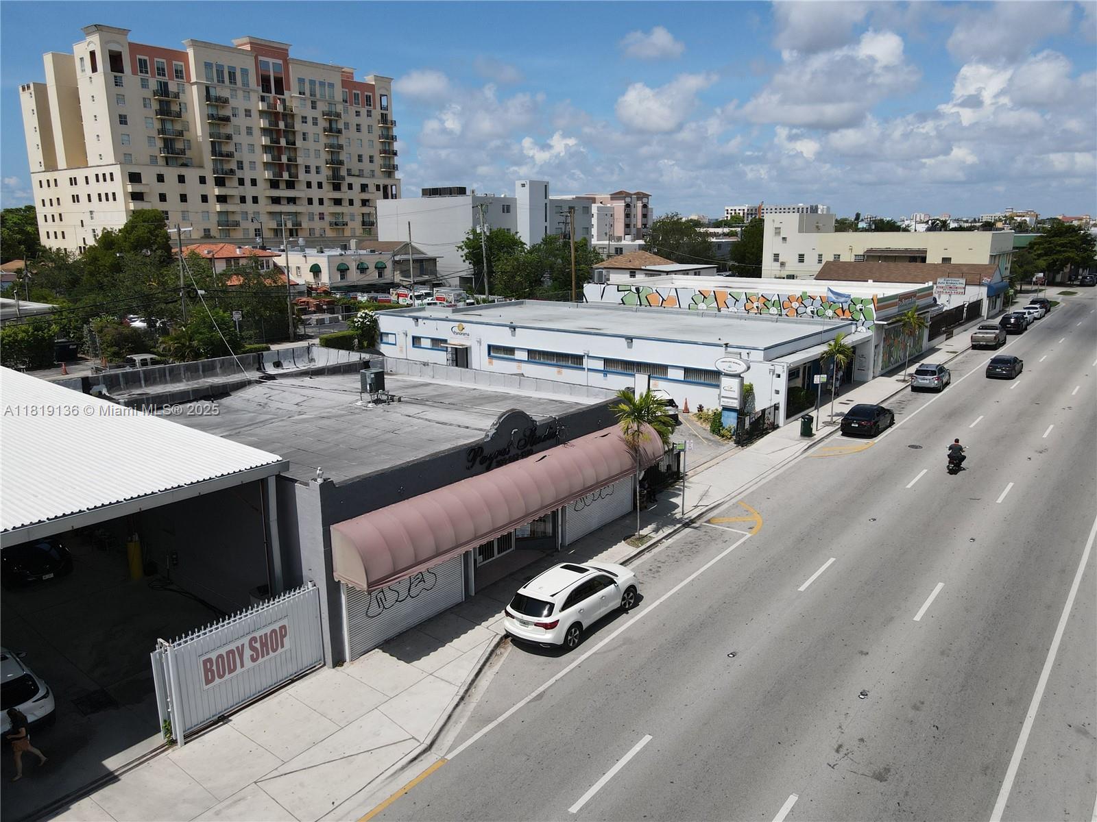 An aerial view shows a commercial building with a body shop and street traffic — 1328 W Flagler St, Miami FL 33135, MIAMI, FL