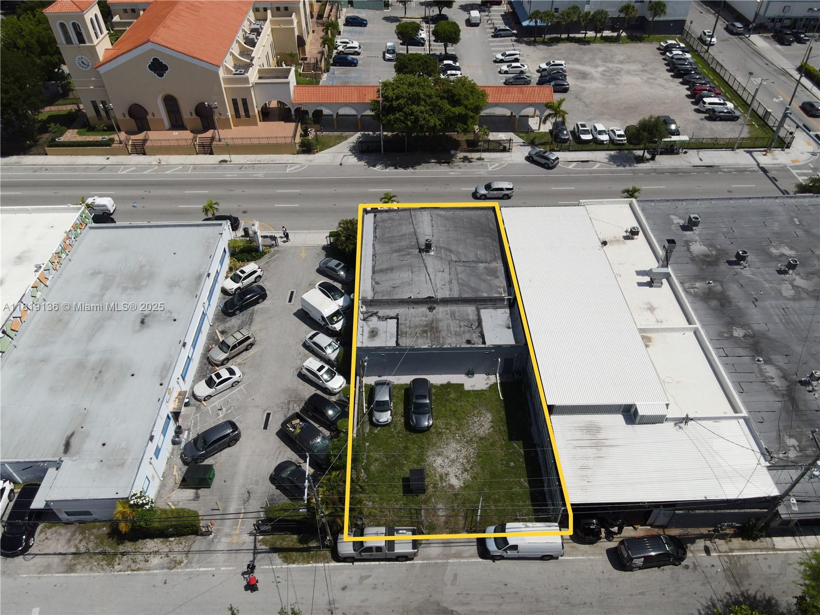 An aerial view shows a commercial building with a fenced rear lot and parking — 1328 W Flagler St, Miami FL 33135, MIAMI, FL