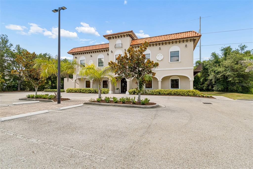 A two-story commercial building with a stucco exterior and a red tile roof — 6730 W LINEBAUGH AVENUE, TAMPA, FL