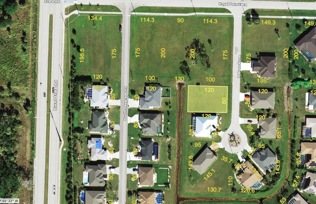 This is an aerial map showing a vacant residential lot highlighted in yellow — 7411 S MOSS ROSE, PUNTA GORDA, FL