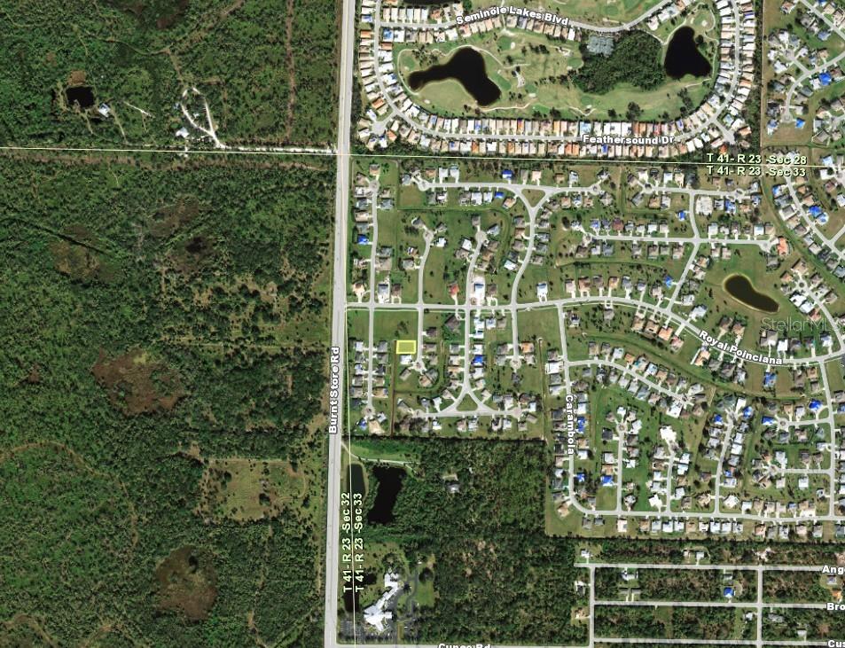 This is an aerial map showing a highlighted vacant residential lot within a suburban neighborhood — 7411 S MOSS ROSE, PUNTA GORDA, FL