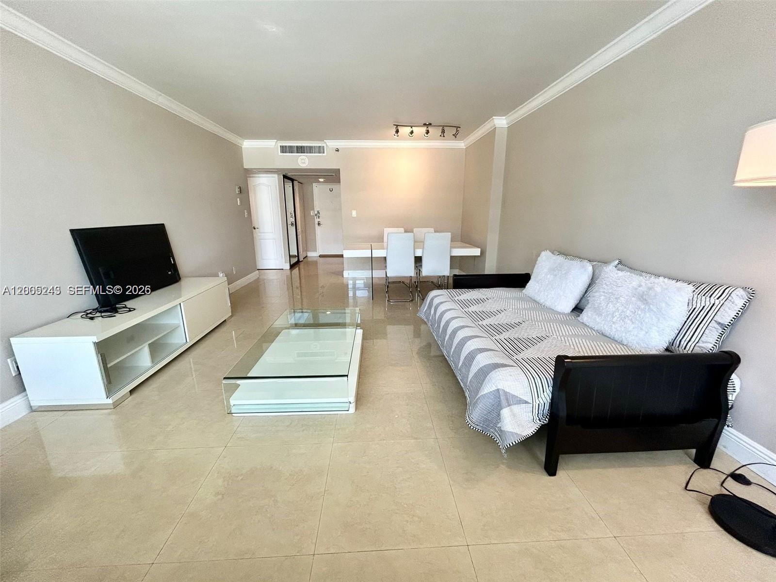 A living room features light tile floors, a white media console, and a daybed — 100 Lincoln Rd # 1010, Miami Beach FL 33139, MIAMI BEACH, FL
