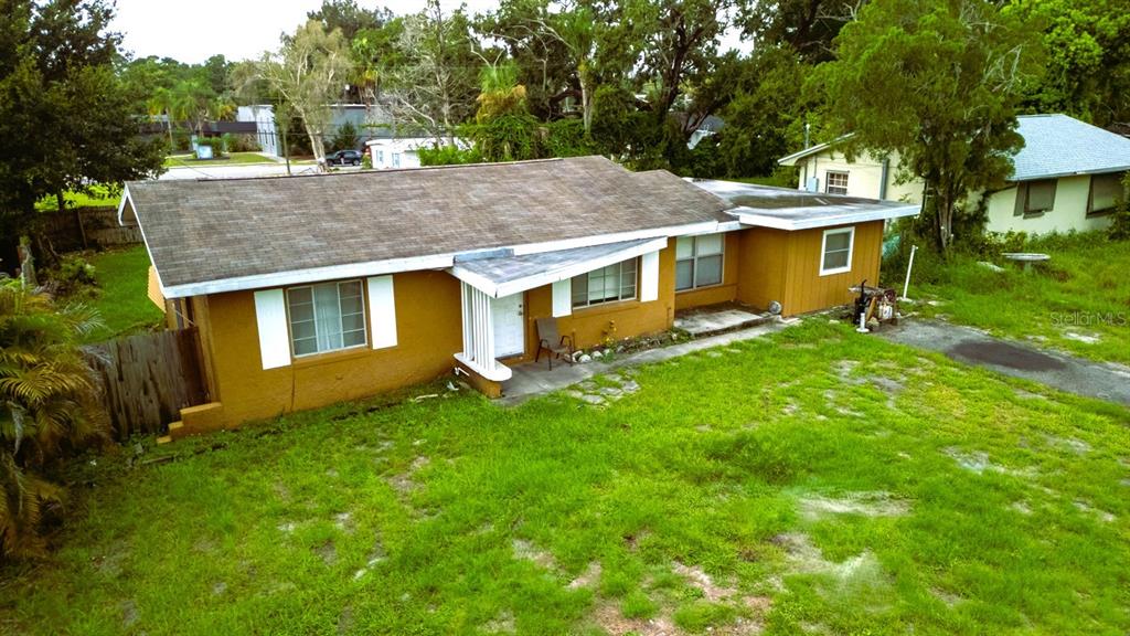 An empty room features a ceiling fan, a window, and an open door to outside — 1329 WOODBINE STREET, CLEARWATER, FL