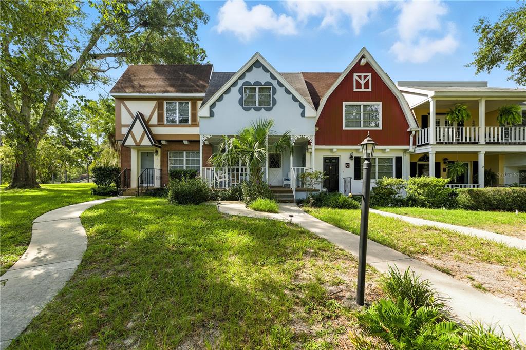 A multi-unit residential building with varied exterior colors and a shared front walkway — 9951 SW 88TH COURT ROAD UNIT B, OCALA, FL