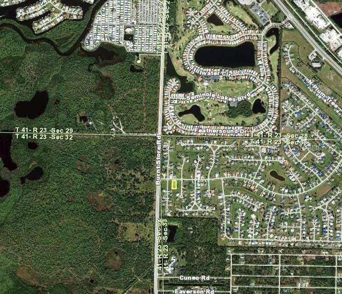 This is an aerial map showing a residential neighborhood and surrounding undeveloped land — 811 ROYAL POINCIANA, PUNTA GORDA, FL