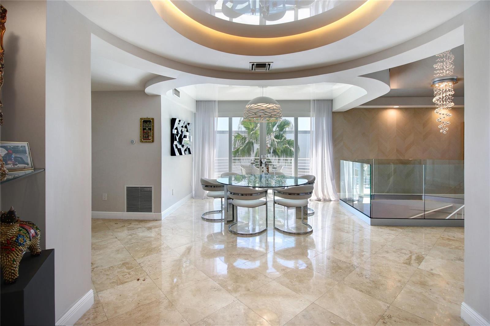 A dining area features a glass table, modern chairs, and a circular tray ceiling — 301 Hendricks Isle # 7, Fort Lauderdale FL 33301, FORT LAUDERDALE, FL
