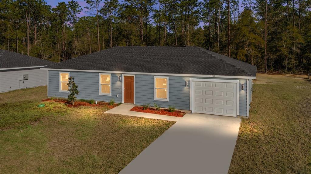A single-story house with blue siding, a brown front door, and a white garage door — TBD SW 30TH STREET, OCALA, FL
