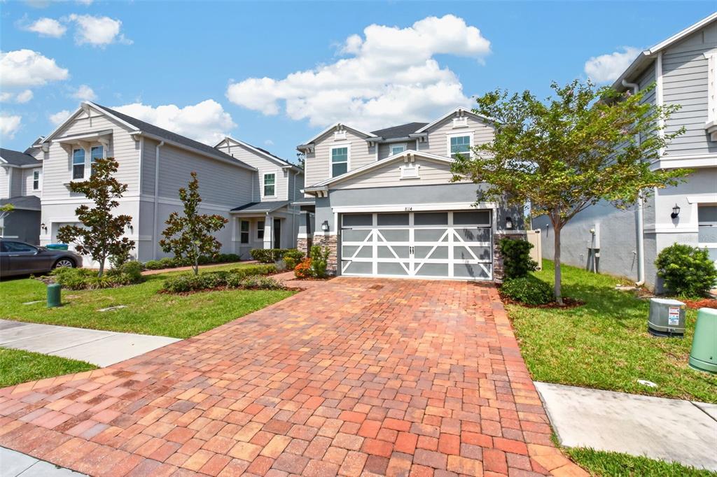 A two-story house with a brick paver driveway and a two-car garage — 8114 ARTISAN CIRCLE, SEMINOLE, FL