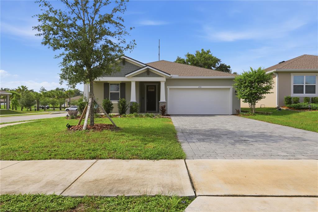 A single-story house with a paved driveway, a two-car garage, and a front porch — 1733 CARNELIAN STREET, DELAND, FL