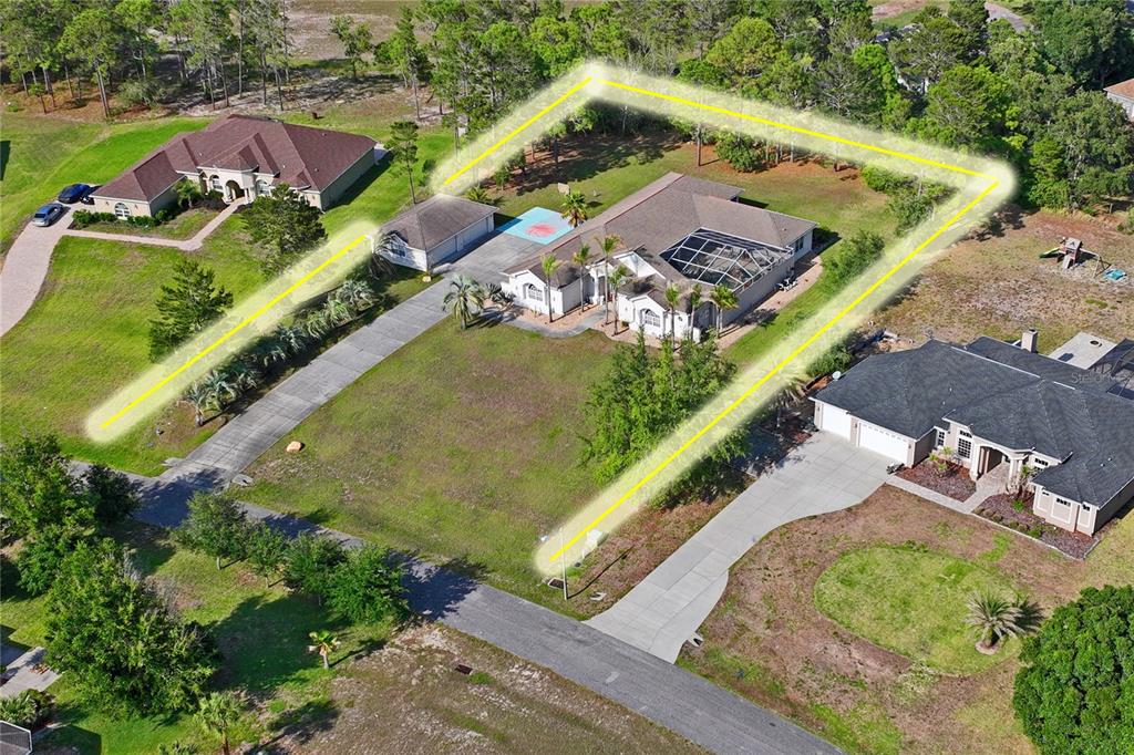An aerial view shows a house with a pool enclosure and a highlighted property boundary — 10120 SHORTLEAF COURT, WEEKI WACHEE, FL