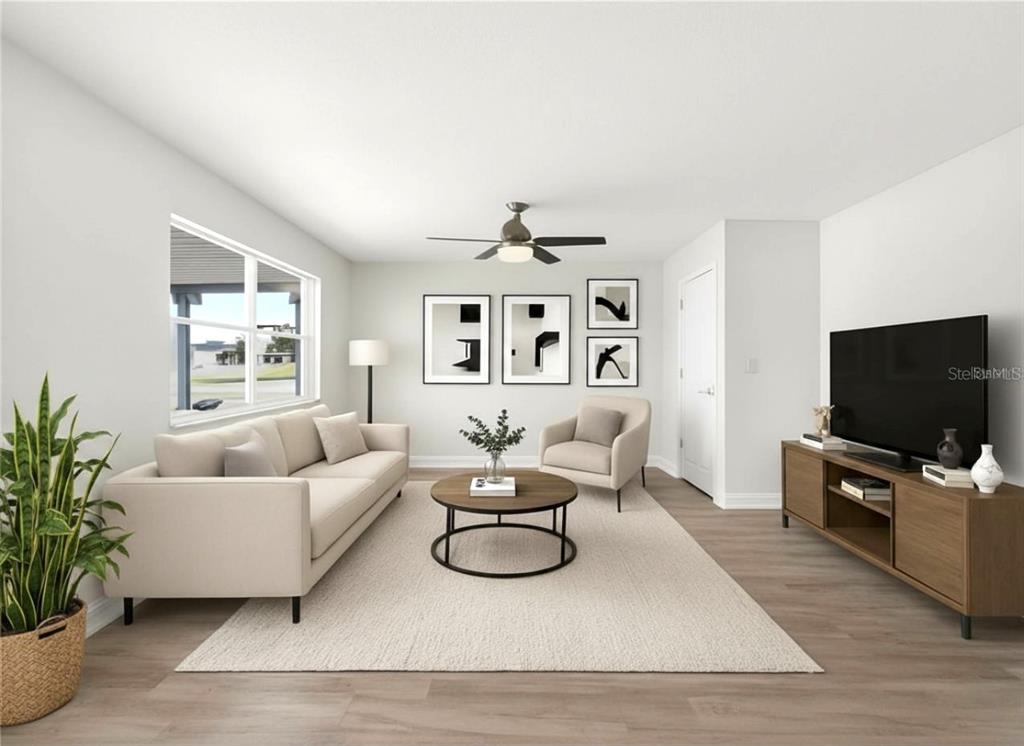 This is a digital rendering of a living room with a sofa, armchair, and television — 1810 MILFORD CIRCLE, SUN CITY CENTER, FL