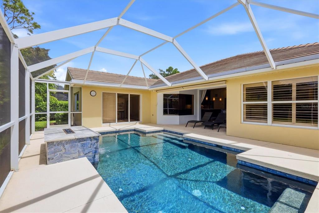 A modern kitchen features gray cabinets, gold hardware, white countertops, and wood-look flooring — 8412 MISTY MORNING COURT, LAKEWOOD RANCH, FL