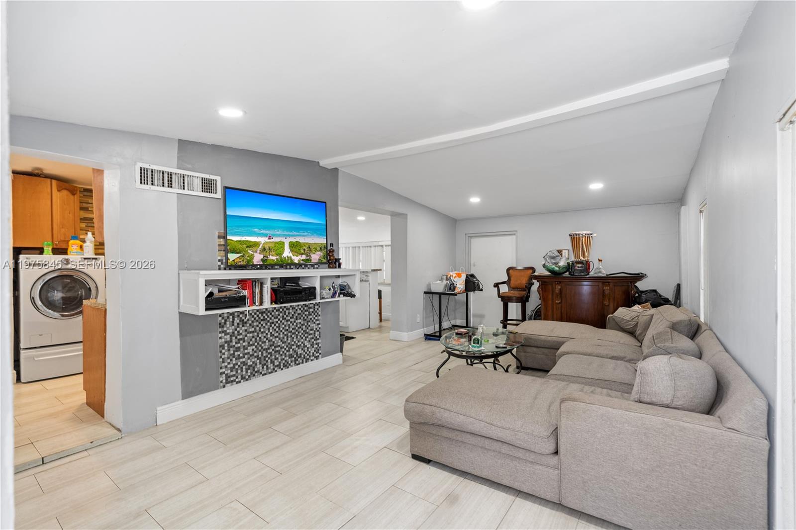 A living room features light tile flooring, a gray sectional sofa, and a wall-mounted television — 4520 SW 38th St, West Park FL 33023, WEST PARK, FL