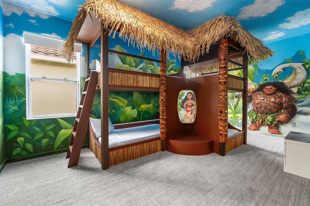 A themed bedroom features a custom Moana-inspired bunk bed structure with a thatched roof — 8013 OAK SHADOW COURT, DAVENPORT, FL