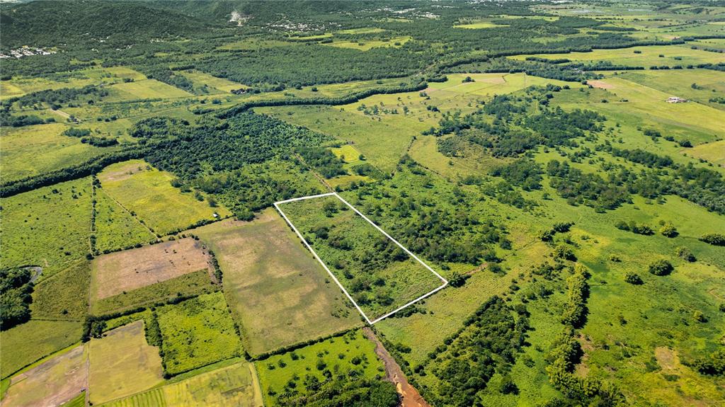 An aerial view shows a rectangular plot of land outlined in white amidst rural fields — 2 KM 162 BENAVENTE ROAD UNIT 630, HORMIGUEROS, PR