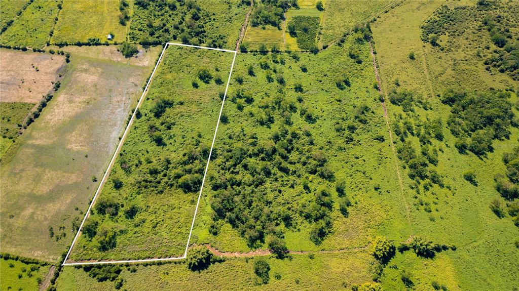 An aerial view shows a rectangular plot of land outlined in white amidst grassy fields — 2 KM 162 BENAVENTE ROAD UNIT 630, HORMIGUEROS, PR