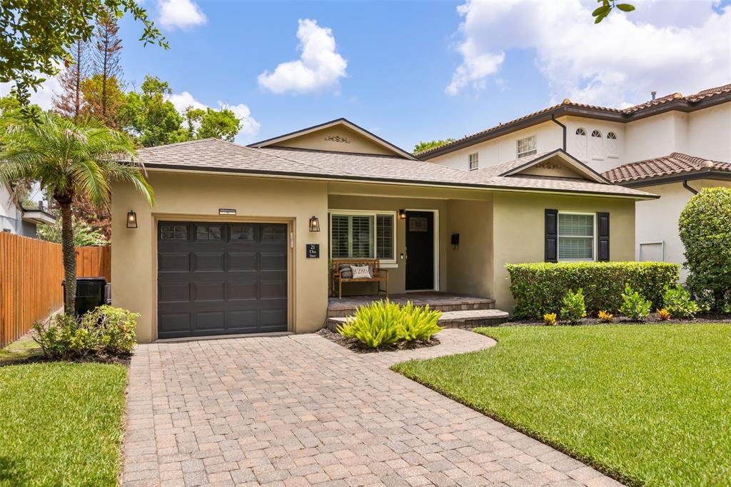 A single-story house with a paved driveway, a one-car garage, and a front porch — 21 E YALE STREET, ORLANDO, FL