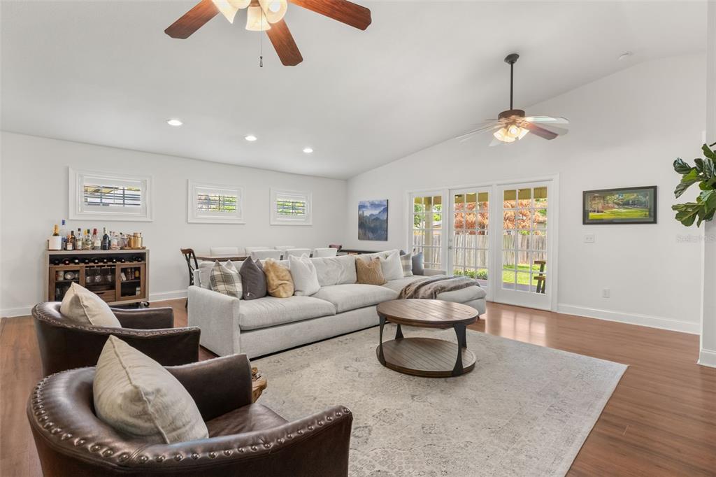 A living room features a large sectional sofa, two leather armchairs, and a wooden coffee table — 21 E YALE STREET, ORLANDO, FL