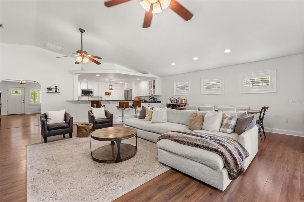A spacious living room features a large sectional sofa, a round coffee table, and hardwood floors — 21 E YALE STREET, ORLANDO, FL
