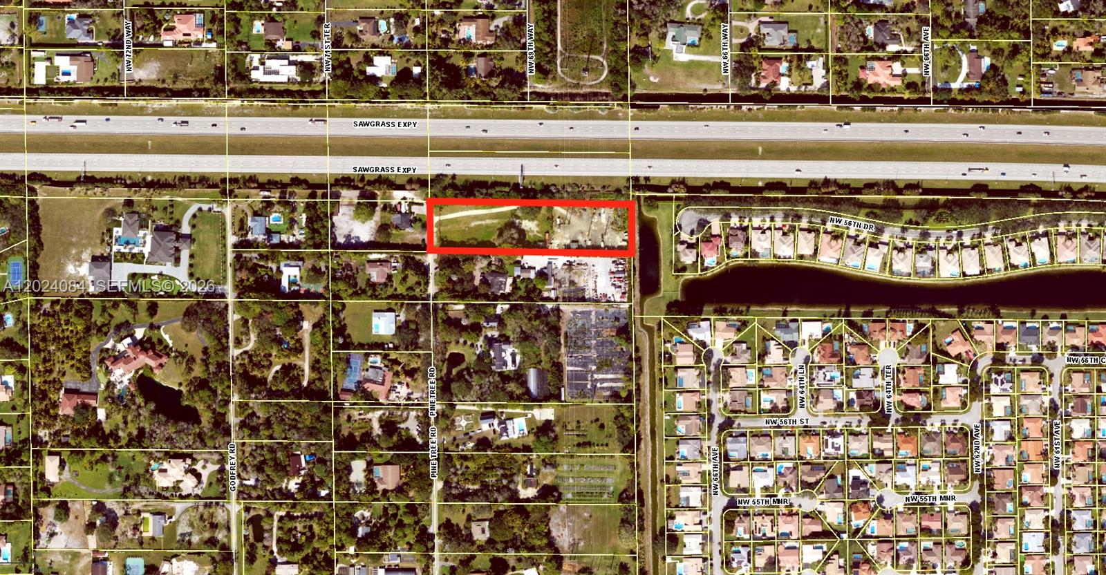 This is an aerial map showing a rectangular property highlighted in red near a highway — 5680 Pinetree Rd, Parkland FL 33067, PARKLAND, FL