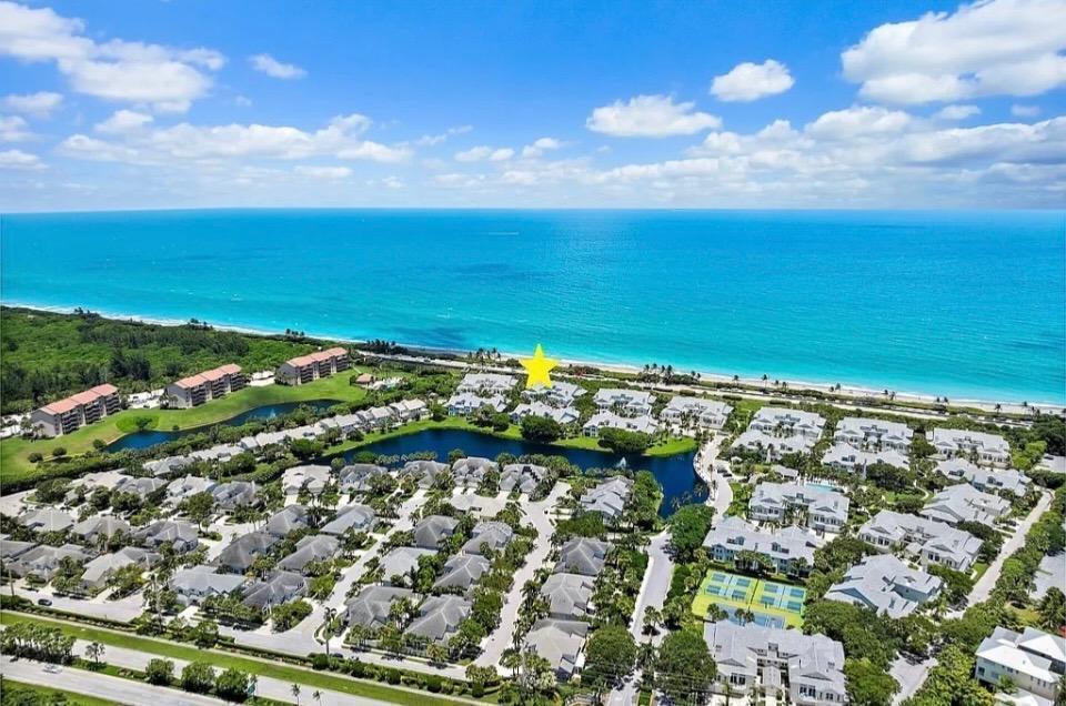 An aerial view shows a coastal residential community with a yellow star marking a building — 602 Mainsail Circle, Jupiter FL 33477, JUPITER, FL