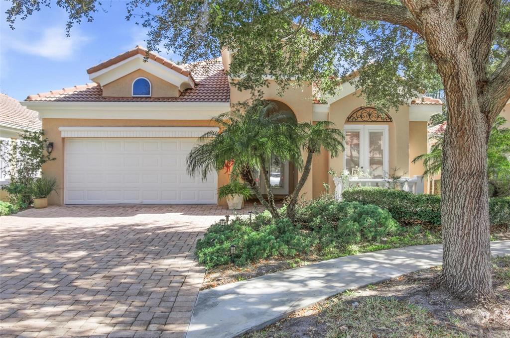 A single-story stucco house with a tile roof, two-car garage, and a paved driveway — 33 MARSHVIEW LANE, PALM COAST, FL