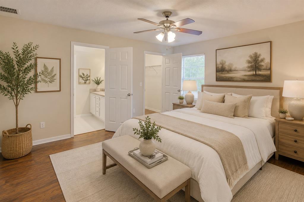 A bedroom features a queen bed, a bench, a ceiling fan, and an attached bathroom — 1360 CHRIS AVENUE, DELAND, FL