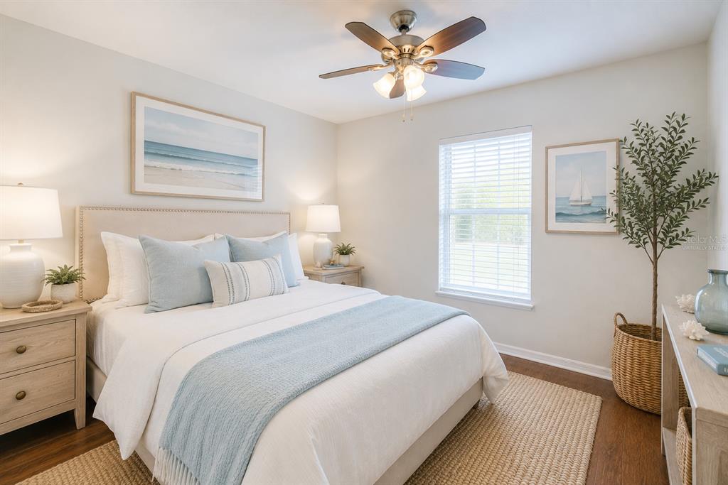 A bedroom features a bed with light blue bedding, two nightstands, and a ceiling fan — 1360 CHRIS AVENUE, DELAND, FL