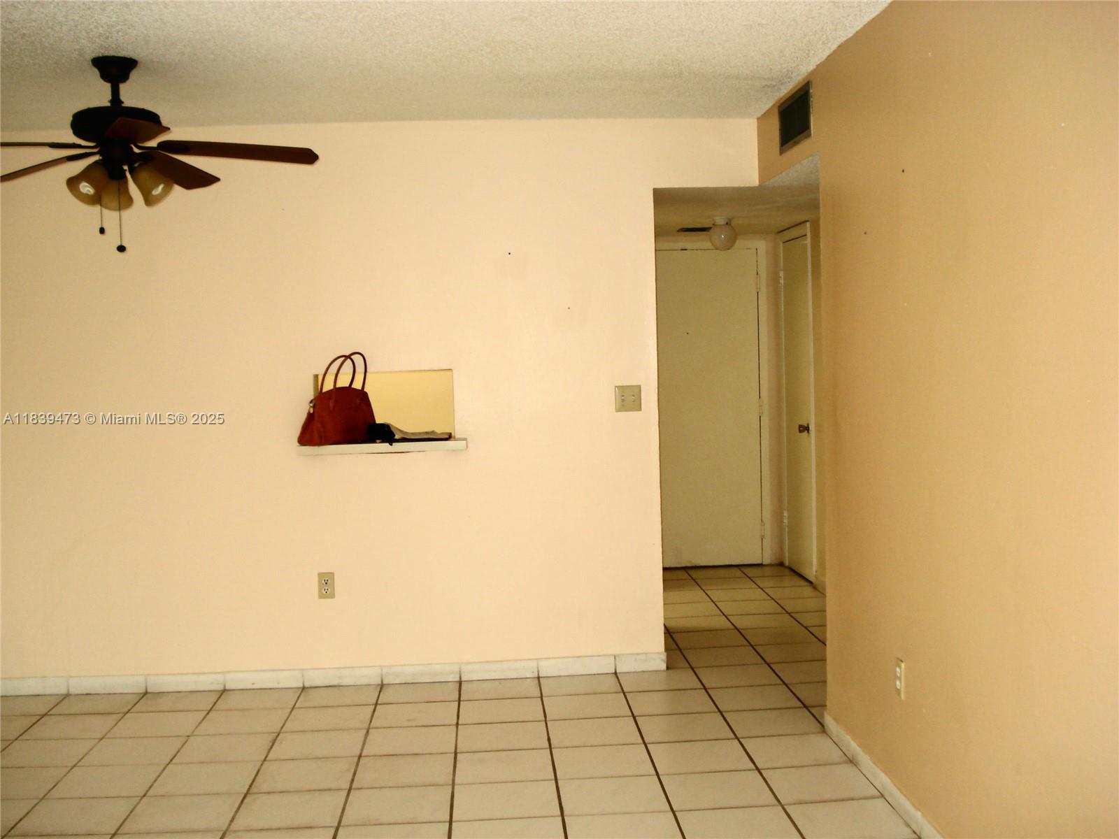 An interior view of a room with tiled floors, a ceiling fan, and a pass-through window — 5755 W 20 Ave # 206, Hialeah FL 33012, HIALEAH, FL