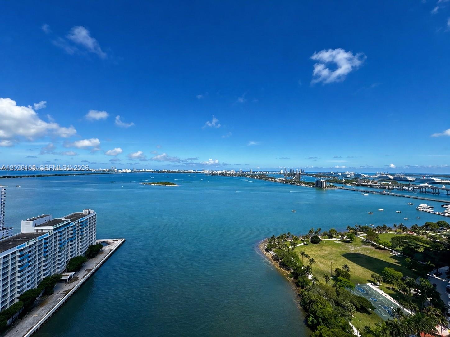 An elevated view of a bay with a large apartment building and a park — 2020 N Bayshore Dr # 2909, Miami FL 33137, MIAMI, FL