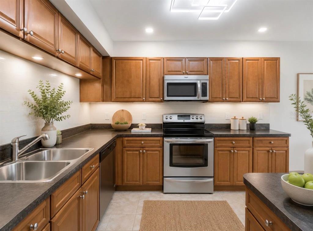 A kitchen with wood cabinets, stainless steel appliances, and dark countertops — 8235 AMBROSE COVE WAY, ORLANDO, FL