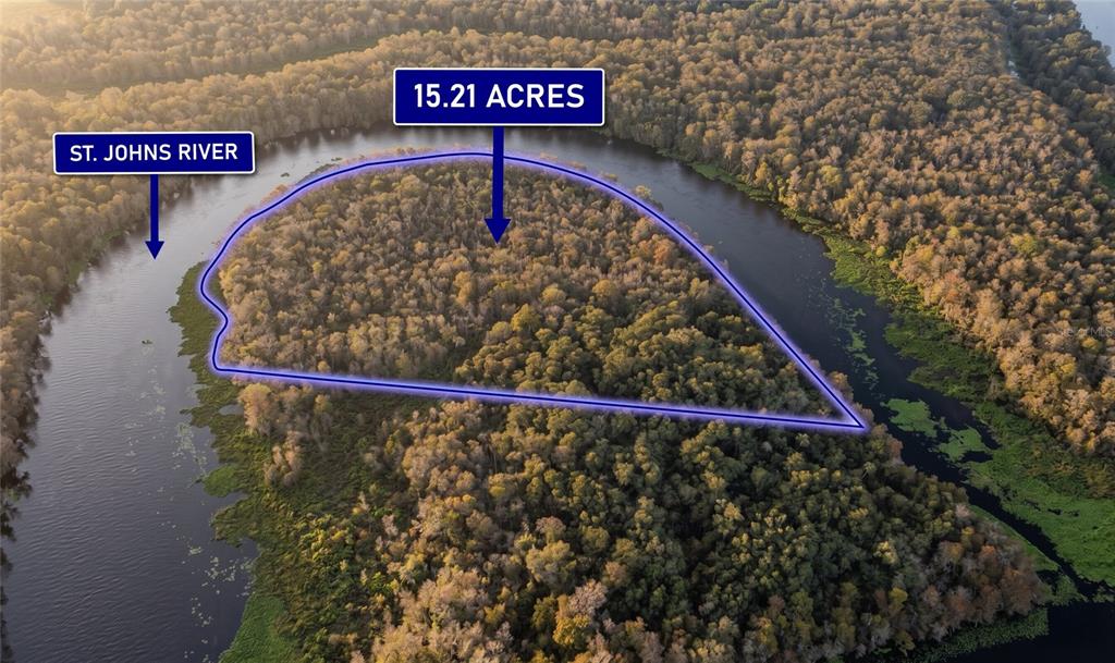 An aerial view shows a wooded 15.21-acre parcel of land bordered by the St. Johns River — 0000 CUMMER ROAD, DELAND, FL