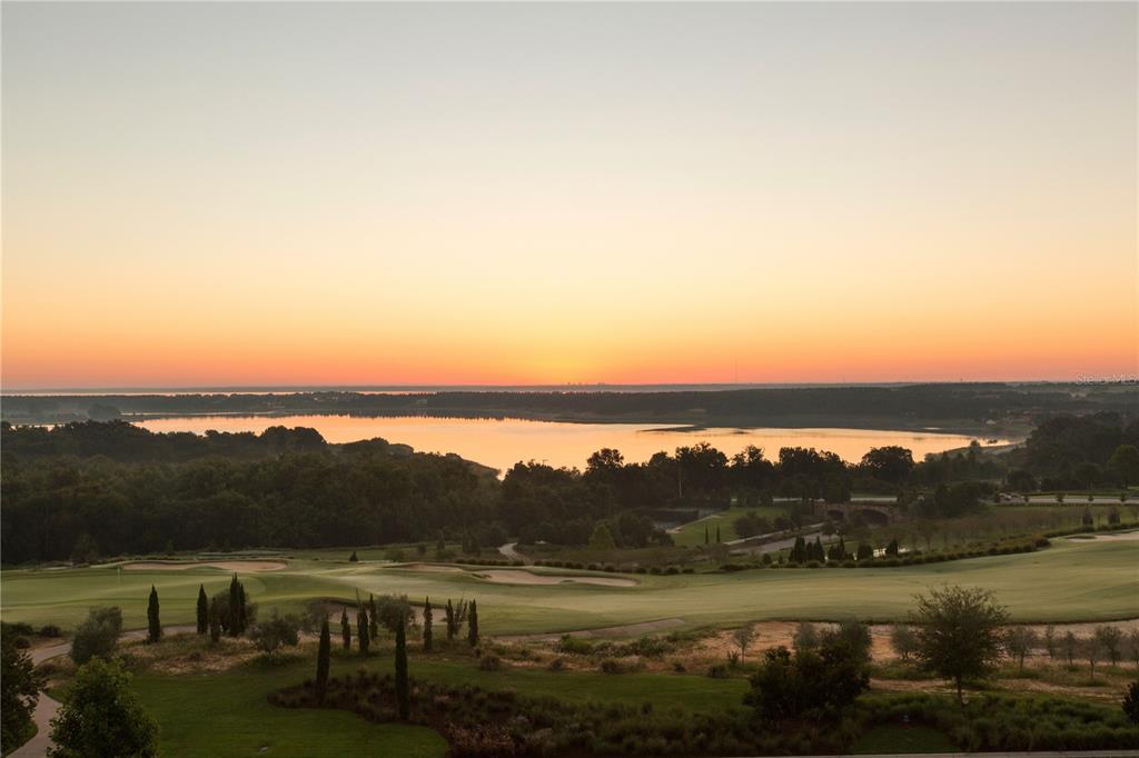 A high-angle view of a golf course overlooking a lake at sunset — 15393 APENNINE WAY, MONTVERDE, FL