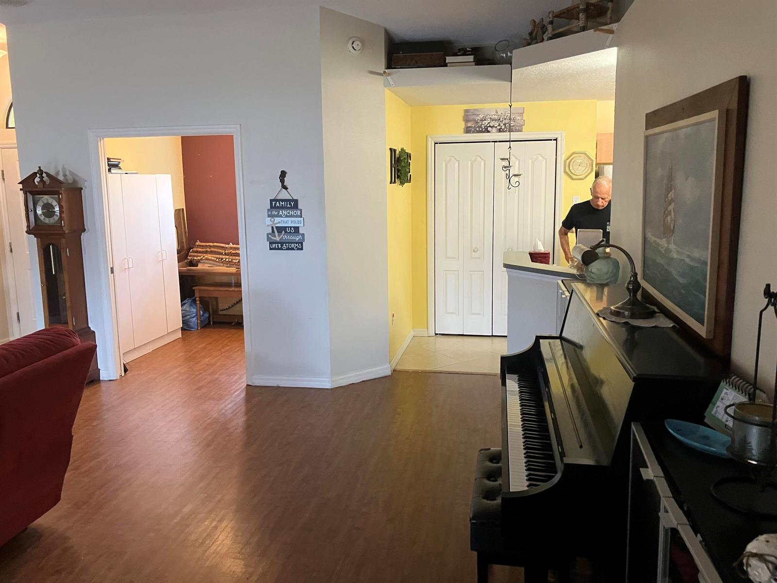 A living area features a piano, a grandfather clock, and a doorway leading to another room — 14050 Brighton Street, Spring Hill FL 34609, SPRING HILL, FL