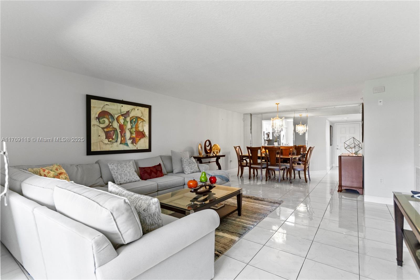 A living room and dining area feature white tile floors, a sectional sofa, and mirrors — 5876 Regal Glen Dr # 101, Boynton Beach FL 33437, BOYNTON BEACH, FL