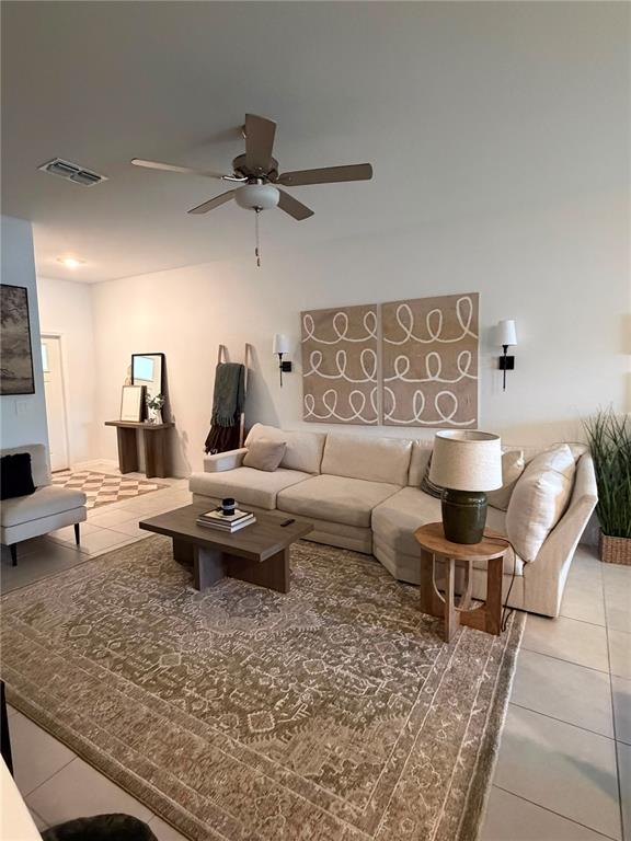 A living room features a large sectional sofa, a coffee table, and a patterned area rug — 21161 THREADFIN WAY, LAND O LAKES, FL