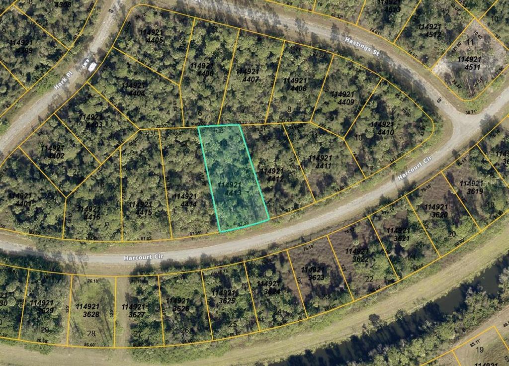 This is a satellite map showing property lot lines and parcel numbers in a wooded area — HARCOURT CIRCLE, NORTH PORT, FL