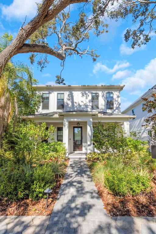 A two-story house with a brick walkway leading to a front porch and entrance — 319 12TH AVENUE NE, ST PETERSBURG, FL