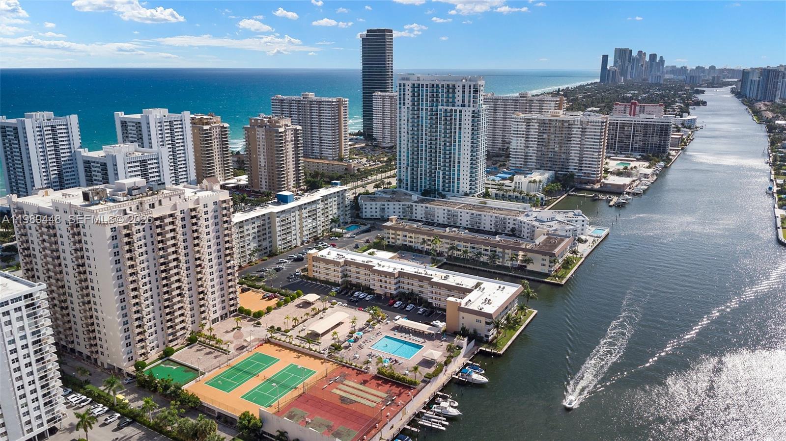 A kitchen island with a stone countertop sits in a bright room with city views — 1865 S Ocean Dr # 21C, Hallandale Beach FL 33009, HALLANDALE BEACH, FL