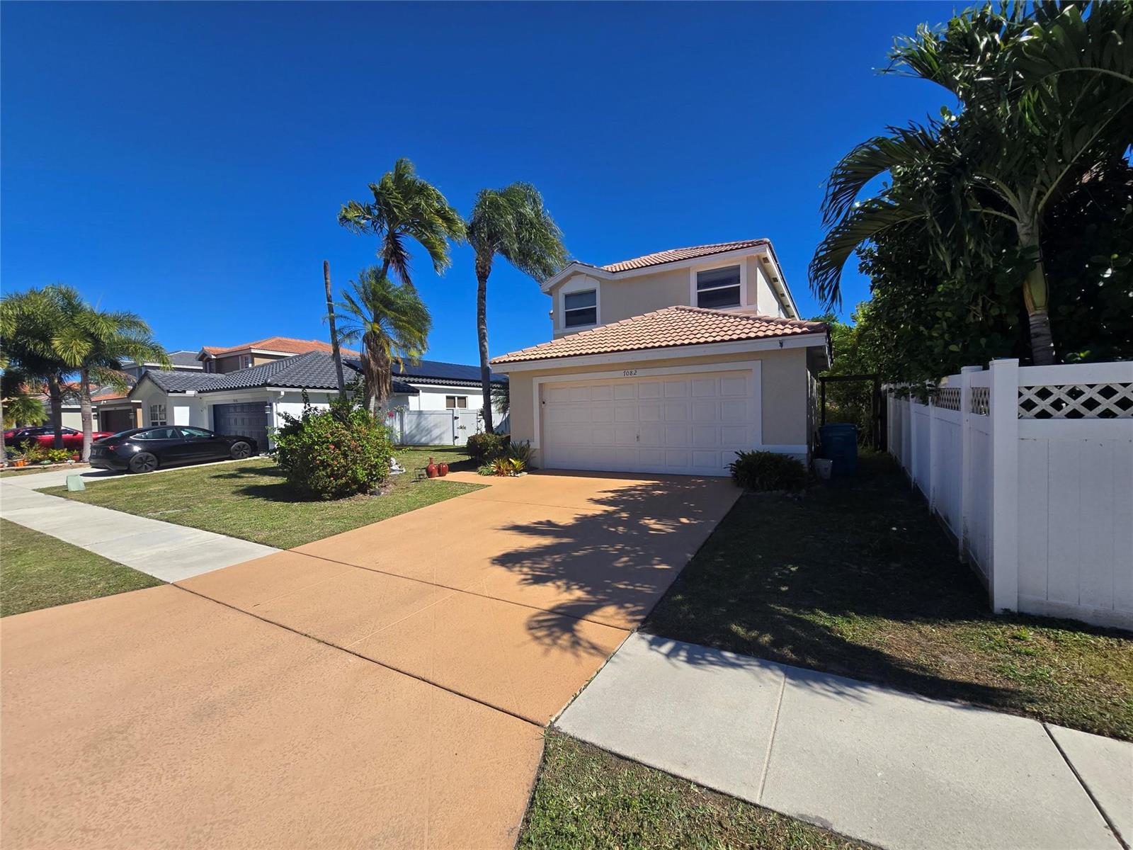 A two-story house with a tan stucco exterior, a tiled roof, and a two-car garage — 7082 Middlebury Drive, Boynton Beach FL 33436, BOYNTON BEACH, FL