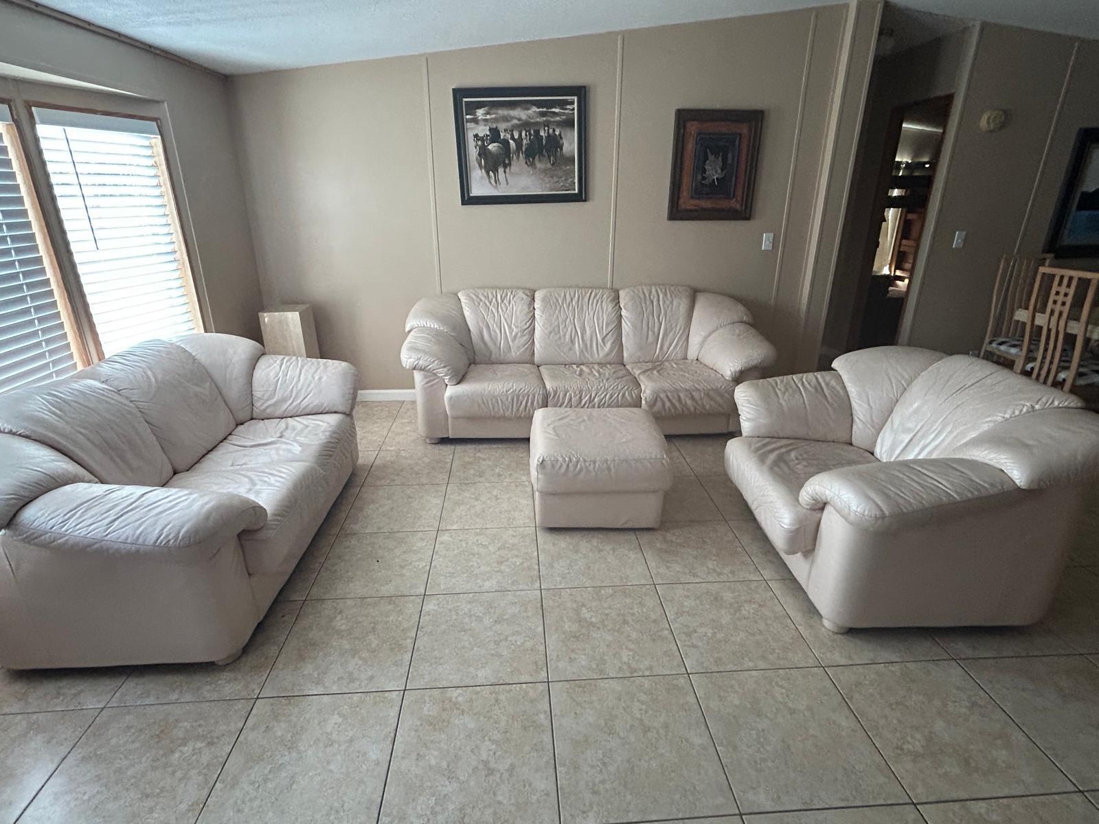 A living room features a white leather sofa set, tile flooring, and beige paneled walls — 6741 NW 193rd Street, FL 32686, FL