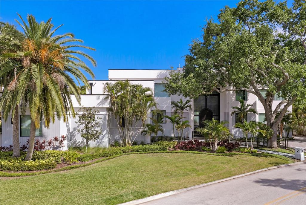 A modern white two-story house features a large palm tree and mature oak trees — 2 SANDPIPER ROAD, TAMPA, FL