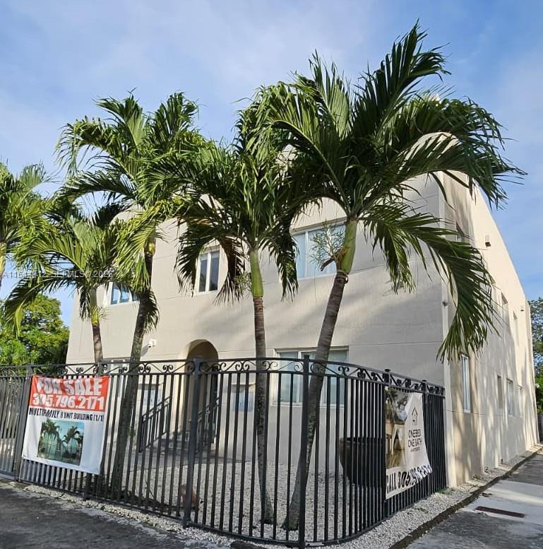 A three-story apartment building with palm trees and a black metal fence in front — 2500 NE 192nd St, Miami FL 33180, MIAMI, FL