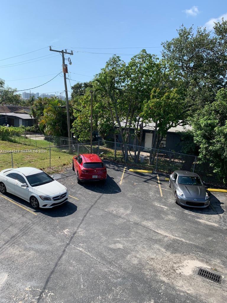 An elevated view of a parking lot with three cars parked in front of trees — 2500 NE 192nd St, Miami FL 33180, MIAMI, FL