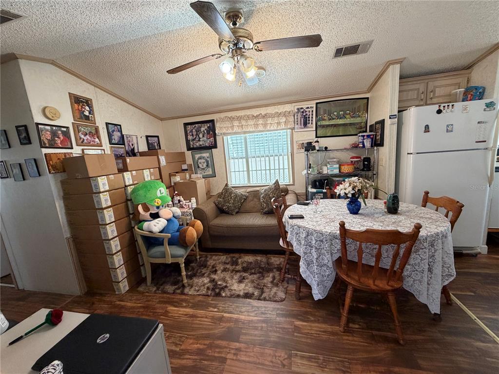 A dining area features a round table, a couch, and a large Luigi plush toy — 337 PANSY STREET, DAVENPORT, FL