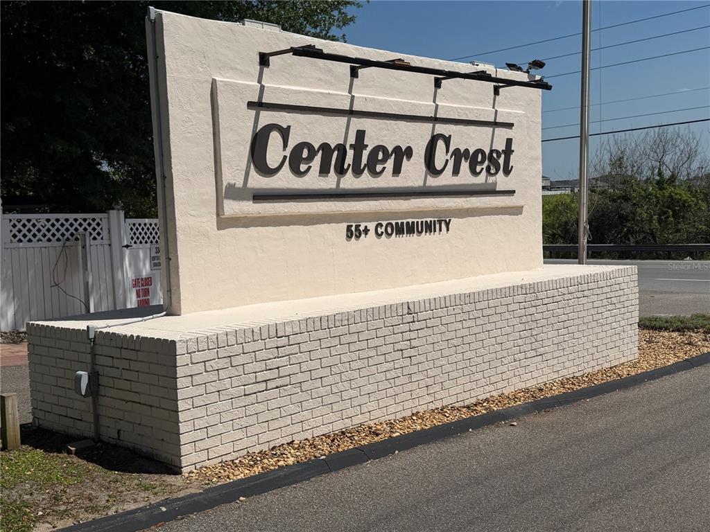 A beige brick and stucco monument sign for Center Crest 55+ Community stands outdoors — 337 PANSY STREET, DAVENPORT, FL
